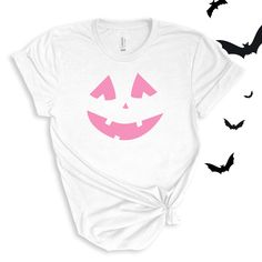 Jack O' Lantern Pumpkin Face graphic in pink or orange. Perfect for this spooky season! Wear to school dress up days, Halloween parties, or just around town for halloween spirit! For All Adult Pumpkin Face T-shirts click here to view.For Adult Sweatshirts click here to view.For Youth/Toddler T-shirts click here to view.For Youth Sweatshirts click here to view.For Baby Bodysuits click here to view. Adult Sizes S-XXL (unisex sizing)Youth Sizes S-XL (unisex Sizing)Toddler Sizes 2T, 3T, 4TBaby Bodysuit Sizes 6 Months, 12 Months, 18 Months Bella + Canvas (Adult, Youth & Toddler T-shirts)4.2 oz. Airlume combed and ring-spun cottonPre-shrunkFor a more relaxed fit, size up! Baby Bodysuit4.5 oz, 100% combed ring-spun cotton fine jerseyInnovative three-snap closure White T-shirt For Costume Party In Fall, Spooky White T-shirt For Costume Party, Cute Halloween T-shirt With Screen Print, Fall Pink Pre-shrunk T-shirt, Fun Halloween Costume Party T-shirt, Fun White T-shirt For Halloween, Jack O Lantern Tie Dye Shirt, Fun White Halloween T-shirt, White Horror T-shirt For Halloween