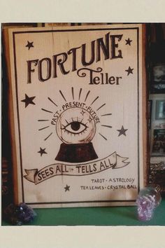 the fortune teller sign is on display in front of some other items, including crystals