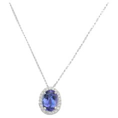 Everyday Halo Diamond Tanzanite Solitaire Necklace in 18K Gold with diamond studded around oval tanzanite. This stunning piece of jewelry instantly elevates a casual look or dressy outfit. Tanzanite brings energy, calmness and happiness into life. Designed with oval cut tanzanite surrounded with diamonds making a stunning delicate necklace. This beautiful handcrafted necklace is a perfect Unique Gift, Bridal Shower Gift, Secret Santa Gift, Gift For Sister, Mother Daughter Gift, Bride To Be Gift, Luxury Oval Tanzanite Necklaces, White Gold Tanzanite Necklace For Formal Occasions, White Gold Tanzanite Oval Necklaces, Elegant Tanzanite Necklace For Formal Occasions, Elegant Oval Tanzanite Necklaces, Formal White Gold Tanzanite Necklace, Elegant Formal Tanzanite Necklaces, Elegant Formal Tanzanite Necklace, Elegant Tanzanite Oval Pendant Jewelry