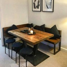 a wooden table sitting next to two black chairs