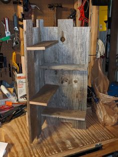 an unfinished wooden shelf in a workshop