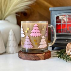 a coffee mug sitting on top of a counter next to a candle holder and other decorations