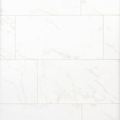 a white marble tile wall that looks like it is being used as a background