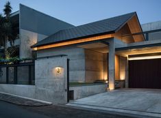 a modern house is lit up at night