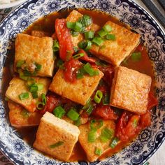 a blue and white bowl filled with tofu