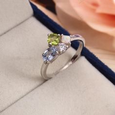 Peridot Opal Cluster Engagement Ring Personalized Multi-stone Aquamarine Moissanite Wedding Ring Birthstone Family Ring Art Deco Anniversary Specification: Stone Name - Peridot, Aquamarine, Opal, Moissanite Shape - Cushion, Oval, Princess Cut, Round Color - Green, Blue, White, White Size - 5mm, 6x4mm , 3mm, 2mm Cut - Faceted Metal Type - 92.5 Sterling Finished With Rhodium Ring Size: We make rings from US 4 to US 16. (If you need smaller or bigger ring size, please ask me to resize) Country of Manufacture: India -------------------------------------------------------- Payment Accepted By PayPal Free Shipping  Standard Delivery Under free shipping services parcel will be delivered within 15 days from the date of dispatch. Speed Delivery : For Fast Delivery kindly pay 30.00 USD extra. Please Sterling Silver Wedding Birthstone Gemstones, Wedding Birthstone Gemstones In Sterling Silver, White Gold Multi-stone Rings For May Birthstone, Opal Diamond Ring For Anniversary, Opal And Diamond Ring For Anniversary, Multi-stone Diamond Opal Promise Ring, Diamond Opal Ring For Anniversary, Diamond Multi-stone Opal Ring For Promise, Cluster Birthstone Diamond Ring For Gift