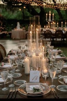 the table is set with candles and place settings