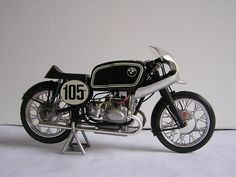 a black and white motorcycle is shown with the number 101 on it's side