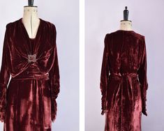 "Vintage 1920s - 30s luxurious burgundy silk velvet dress. V neckline bodice with bolero style capelet attached. Decorative diamanté dress buckle in centre with gathered bust. Two panels draped over back. Longe sleeves, with cold shoulders (split at the top) and gathered sections near the petal shaped cuffs (with poppers). Wide gathered sash belt at waist. Hidden poppers at side. No labels, possibly tailor or hand made. Feels like silk velvet. Very unusual glamorous dress with nods to the Edward Vintage Burgundy Dress For Evening, Burgundy Vintage Evening Dress, Vintage Burgundy Evening Dress, Art Deco Velvet Dress, Velvet 1920s Dress, Vintage Velvet Costume Outerwear, Luxury Vintage Silk Flapper Dress, 1930 Velvet Dress, Silk Velvet Dress