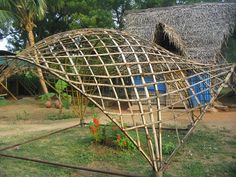 a house made out of bamboo sticks in the yard