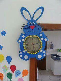 a clock that is on the side of a wall with balloons and a bunny face