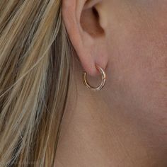 These small gold hoop earrings are handmade by me in the beautiful Pacific Northwest of North America. They are made of solid 14k yellow gold They also have locking 14k gold backs and posts. Size: 16mm exterior diameter, 13mm interior diameter. 2mm wide and 1.5mm thick. I strive to run an ecologically sustainable business. Because my jewelry is made using hand fabrication processes, it has lightness, durability and detail unachievable via mass production. Read more about me here: https://www.ets Dainty Polished Hoop Earrings As Gift, Minimalist Hammered Huggie Jewelry, Minimalist Everyday Hammered Huggie Earrings, Everyday Minimalist Hammered Huggie Earrings, Dainty Hammered Yellow Gold Hoop Earrings, Delicate Yellow Gold Small Hoop Huggie Earrings, Simple Yellow Gold Huggie Earrings, Minimalist Hammered Hoop Earrings For Anniversary, Small Silver Hoop Earrings