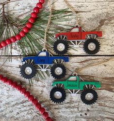 two christmas ornament shaped like trucks hanging from a tree