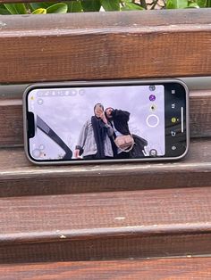 a cell phone sitting on top of a wooden bench