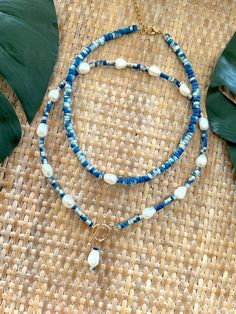 Welcome to our Coastal Inspired Beaded Pearl Necklace – a stunning blend of elegance and coastal charm, inspired by the breathtaking coastline of Santorini, Greece! 🌊✨Crafted with care and attention to detail, this necklace features a beautiful combination of unique tie-dyed bright blue and white coconut shell heishi beads, reminiscent of the colors of the Aegean Sea, and lustrous 9mm freshwater pearls. Each bead is carefully selected to evoke the serene beauty of Santorini's coastline, creatin Blue Bohemian Pearl Necklace For Gift, Adjustable Polished Beads Necklace For Beach, Adjustable Polished Bead Necklaces For Beach, Blue Necklaces For Summer Beach, Ocean-inspired Beaded Jewelry, Handmade Strand Jewelry In Ocean Color, Handmade Ocean Color Necklaces For Beach, Handmade Strand Ocean Color Jewelry, Handmade Ocean-colored Strand Jewelry