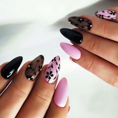 a woman's hands with pink and black nail polishes on their fingertipss