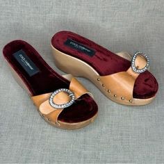 Rescue items are less than perfect with some defects present. Gorgeous Vintage D&G wooden clogs with luxurious velvet lining. Blingy buckles and natural uncoated cowhide tops. The wood is lacquered and shiny. Size 36.5 US or 7 European Missing one crystal, leather has some stains and may need to be reglued in some places SOLD IN AS-IS CONDITION Luxury Leather Clogs With Wooden Heel, Luxury Leather Footbed Slip-on Clogs, Luxury Open Toe Clogs With Removable Insole, Brown Wedge Heel Clogs With Buckle Closure, Luxury Brown Closed Toe Clogs, Luxury Open Toe Clogs With Leather Sole, Luxury Brown Clogs With Round Toe, Clogs And Mules, Wooden Clogs