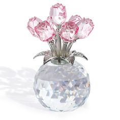 a crystal vase with pink roses in it