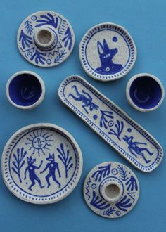 five blue and white pottery pieces with designs on them, all in different shapes and sizes