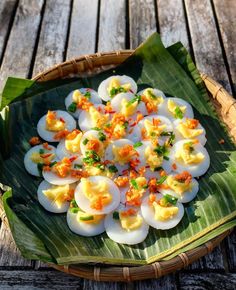 an egg dish is served on a banana leaf