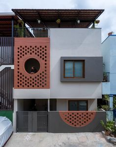 an apartment building with two balconies on the second floor