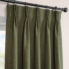 the curtain is closed and ready to be hung in front of a window with green curtains