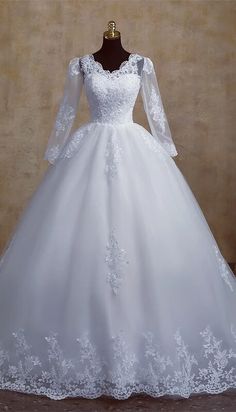 a white wedding dress on a mannequin with long sleeves and sheer laces