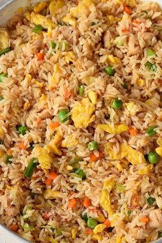 rice and vegetables mixed together in a pan