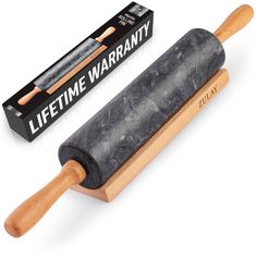 a rolling stone with wooden handle next to a box of life time warrant waxing