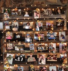 a wooden shelf with pictures and lights on it