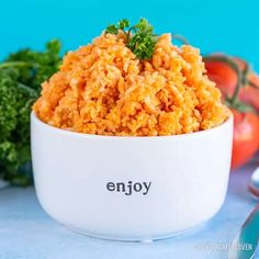 a white bowl filled with food next to tomatoes and broccoli on a table