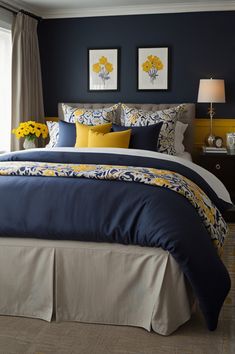 a bed with blue and yellow comforters in a bedroom next to a window,