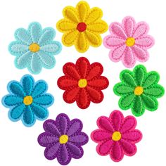 four different colored flowers are shown in the shape of a circle on a white background