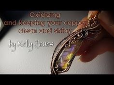 a person holding a piece of jewelry with the words oxidizing and keeping your copper clean and shiny