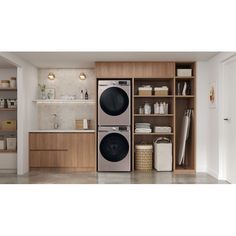 a washer and dryer in a room with open shelves on the wall next to each other