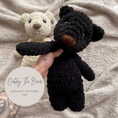 two crocheted teddy bears sitting next to each other on a bed with white sheets