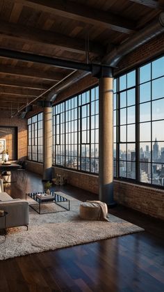 a living room filled with furniture and large windows overlooking the cityscape in the distance