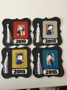 four pictures are hanging on the wall with graduation caps and tassels around them