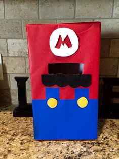 a red and blue bag sitting on top of a counter next to a brick wall