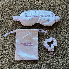 the baby sleep mask is next to its pouch and hair tie on the carpeted floor