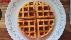 two waffles cut into four on a white plate with blue and green designs