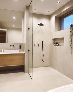 a bathroom with a walk in shower next to a sink