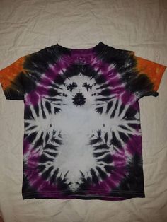 a t - shirt that has been dyed with purple and orange colors