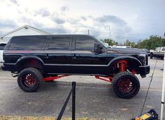 a large black truck parked in a parking lot