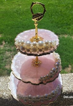 three tiered tray with pearls and a ring on top