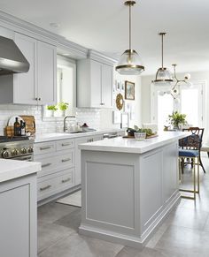 a kitchen with white cabinets and an island