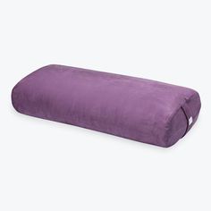 a purple pillow on a white background