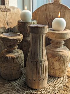 three wooden candles sitting on top of a table