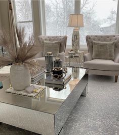 a living room with two couches and a coffee table in front of a window