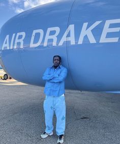 a man standing in front of an airplane with the word air draake on it